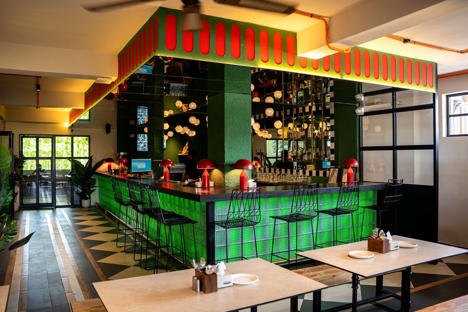 The green lit Shalimar bar with red lamps